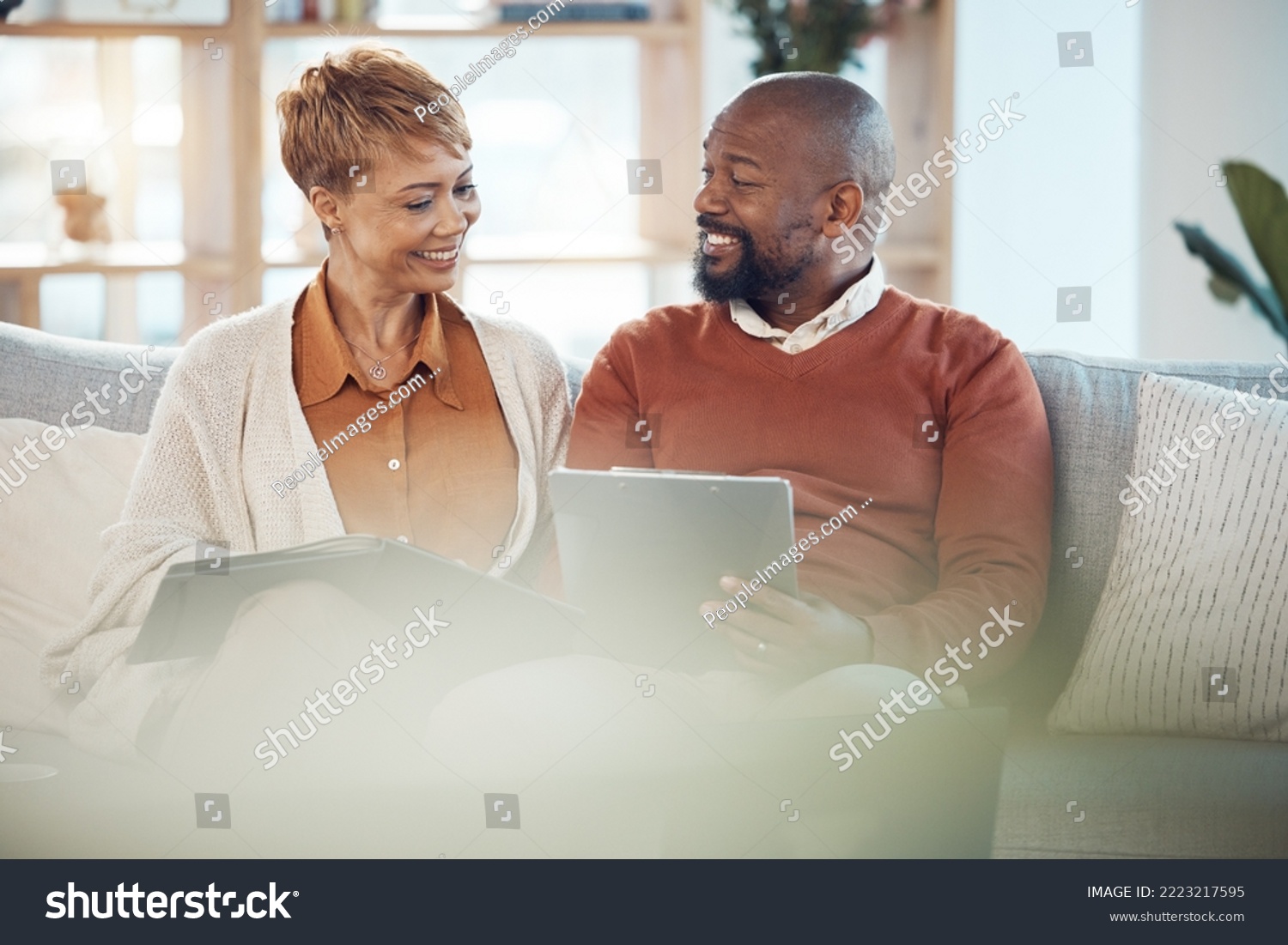 Two people smiling and talking while working together